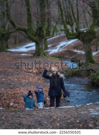 Spain, zeanuri, January 2023; family portrait in the snowy forest