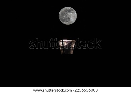 Full Wolf moon over lantern