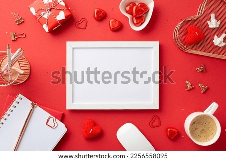 Top view photo of white photo frame stationery holders diary computer mouse heart shaped saucer with candies present box candles mug of coffee and sequins on isolated red background with empty space