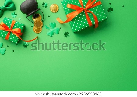 Saint Patrick's Day concept. Top view photo of green present boxes with orange ribbon bows pot with gold coins tie bow clovers and confetti on isolated green background with empty space