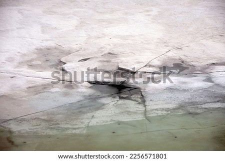 Frozen River Cracking From Ice Melt Royalty-Free Stock Photo #2256571801