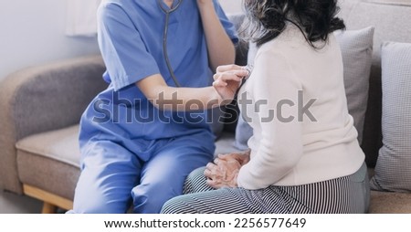 Homecare nursing service and elderly people cardiology healthcare. Close up of young hispanic female doctor nurse check mature caucasian man patient heartbeat using stethoscope during visit