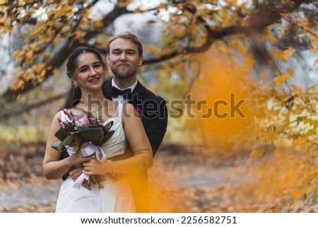 Portrait of newlyweds couple in a park - copy space. High quality photo