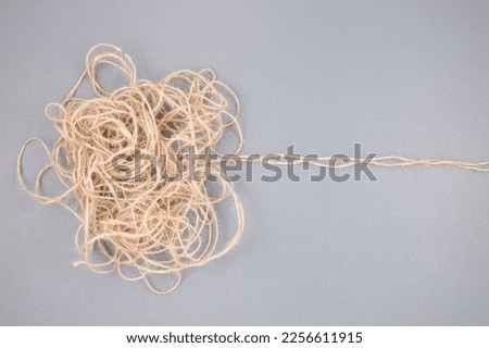 The tangled rope concept with trace lines as the root of the problem, or solution, unravels the confused rope, mental problem, or difficult situation that is hard to resolve Royalty-Free Stock Photo #2256611915