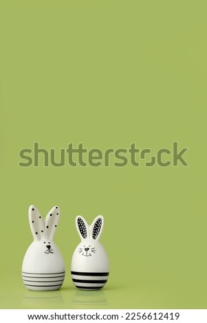 Statuettes of Easter rabbits on the blue background. Festive picture with place for text