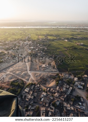 Aerial view of the Nile river and Luxor from a hot air balloon during sunrise.