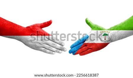 Handshake between Equatorial Guinea and Indonesia flags painted on hands, isolated transparent image.
