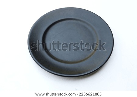 top view and flat lay a empty black ceramic plate on white background.horizontal photo