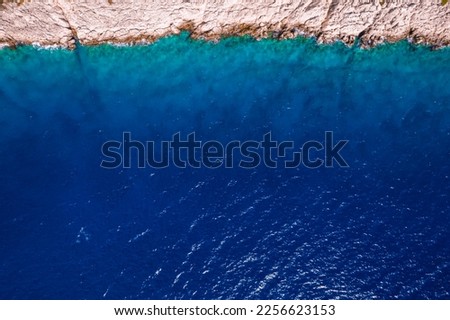 A picture from a drone top view of a rock in the azure amazing Mediterranean Sea. Beautiful travel background. High quality photo