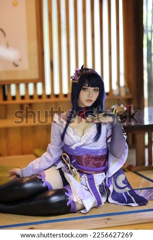 Portrait of a beautiful young woman game cosplay with samurai dress costume