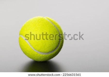 tennis ball on grey background with copy space Royalty-Free Stock Photo #2256631561