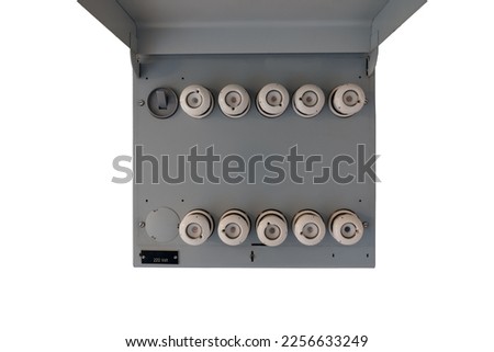 Old electrical fuse box with porcelain fuses in an older dwelling house, power and energy concept. Isolated on white background. Royalty-Free Stock Photo #2256633249