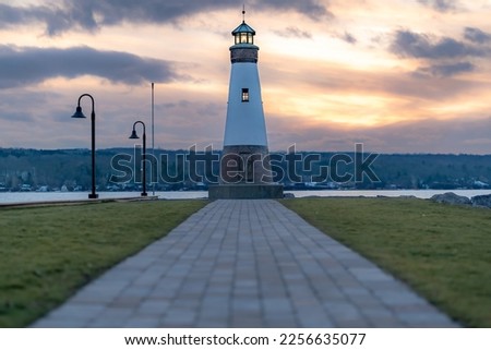 Sunset photo of the Myers Point Lighthouse at Myers Park in Lansing NY, Tompkins County. The lighthouse is situated on the shore of Cayuga Lake, near Ithaca New York.	
