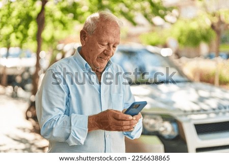 Senior grey-haired man smiling confident make selfie by smartphone at street