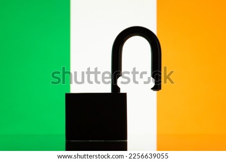 Flag of Ireland with silhouette of lock on the foreground. Reopen Ireland, open borders concept