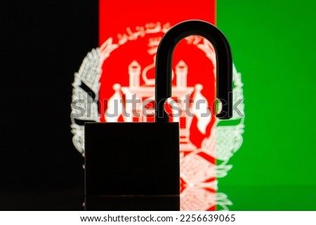 Flag of Afghanistan with silhouette of lock on the foreground. Reopen country Afghanistan, open borders concept