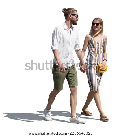 Man and woman walking casually hand in hand on a sunny summer day isolated on white background Royalty-Free Stock Photo #2256648325