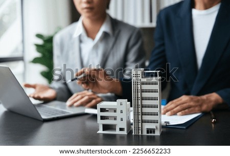 Discussion with a real estate agent. Real estate agent having a discussion with his client about purchasing house. Royalty-Free Stock Photo #2256652233