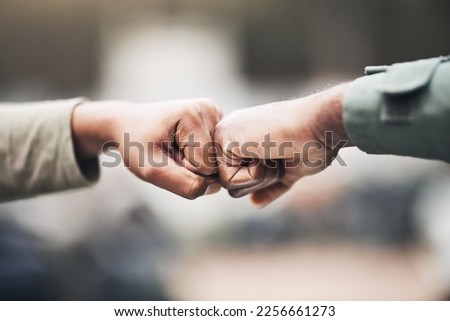 People, hands and fist bump for agreement, deal or trust in partnership, unity or support on a blurred background. Hand of team touching fists for community, teamwork or collaboration in the outdoors Royalty-Free Stock Photo #2256661273