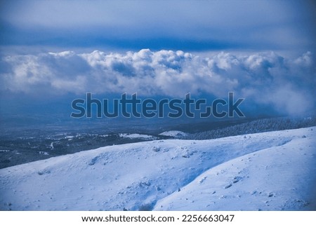 A snowy and cloudy mountain landscape