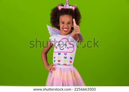 beautiful little afro girl with thumb up doing ok, positive sign.