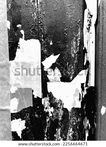 A black and white overexposed picture of paper chipping off a wall in New York City. 