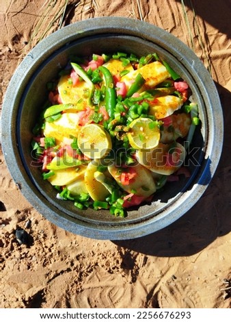 A Moroccan Tagine is a traditional dish cooked over low heat. It's typically a slow-cooked stew filled with aromatic spices and ingredients like meat, vegetables enjoying it in the desert nature