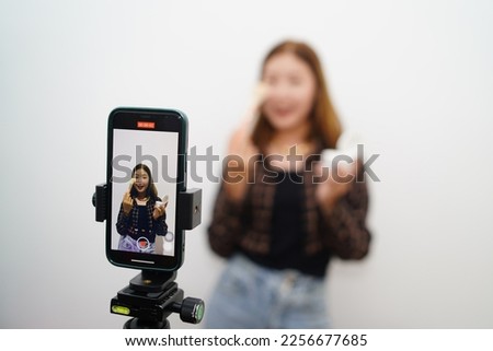 Asian vlogger female influencer shows how to make up live on IG story reel tiktok at home studio. Gen Z people film selfie shooting app viral videos. Royalty-Free Stock Photo #2256677685