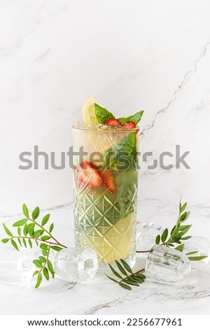  Strawberry and orange lemonade.Fresh fruit lemonade drinks. Orange cocktail  with strawberries. Fresh summer cocktail. Glass of frozen cocktail mojito on white background.