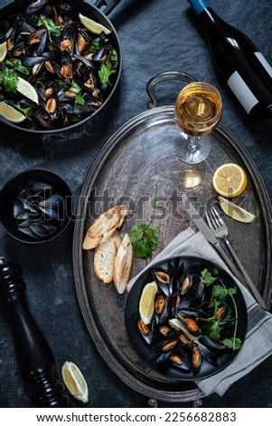 Mussels, wine and bread. Colorfully served table with seafood. Top view.