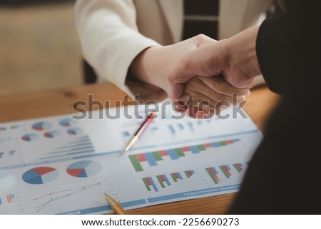 Business investor group holding hands, Two businessmen are agreeing on business together and shaking hands after a successful negotiation. Handshaking is a Western greeting or congratulation. Royalty-Free Stock Photo #2256690273