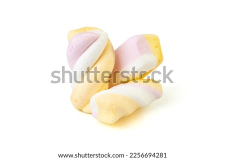 Multi-colored twisted marshmallows, soft focus close up, isolated on white 