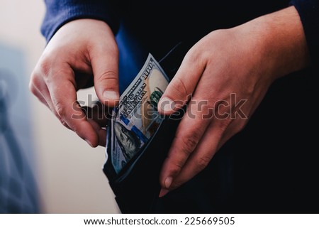 Purse with dollars in their hands.