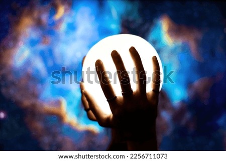 A studio shot of someone holding a star.