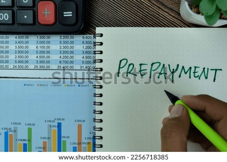 Concept of Prepayment write on a book isolated on Wooden Table.