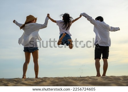 family playing at the beach. happy asian family playing fun on beach
