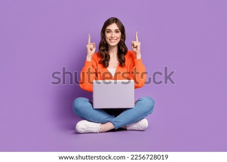 Full length photo of cute pretty lady wear cardigan pointing up empty space working device isolated violet color background