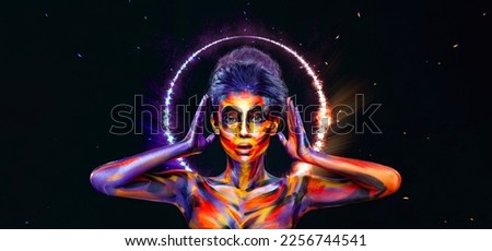 Girl in a glowing neon circle. Woman in color body painting on her face. Cover art for your mixtape, video, song or podcast. Design for book covers.