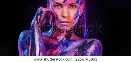 Woman in neon lights. Portrait of dancer at club party. Body art with bodypaint. Download cover for art book.