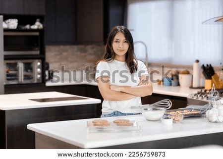 Proud hispanic woman in her kitchen-Young woman preparing cookies at home-Modern woman in the kitchen