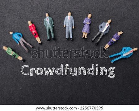 Miniature people with the word Crowdfunding. Business concept.