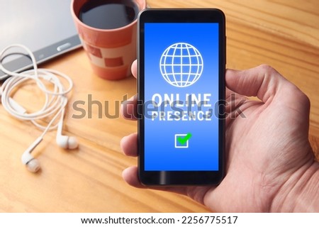 Male hand holding mobile phone with online presence report showing positive result on screen. Strong online presence concept, search engine optimization and digital marketing.