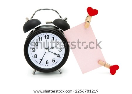 Retro alarm clock and greeting blank card with hearts on clothespins isolated on white background. Time for love.