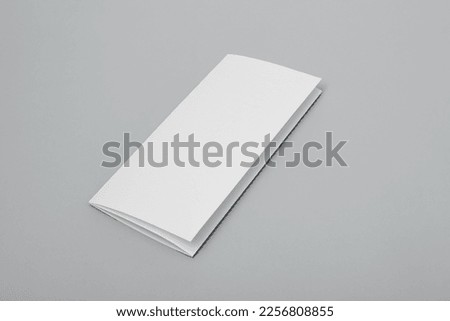 Blank paper folded on gray background