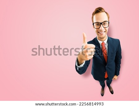 Full body businessman in eye glasses, black suit show thumb up like, agree hand sign gesture, on pink background. Comic cartoon style funny man in eyeglasses, big head. Funny face. Expert recommending