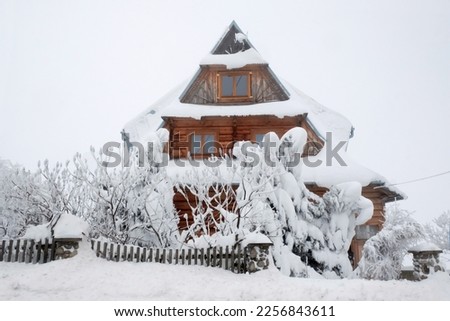 Beautiful winter scenery with snowy wooden traditional building in Podhale village, Poland. During trip: Banska Wyzna - Sirockie - Zab Royalty-Free Stock Photo #2256843611