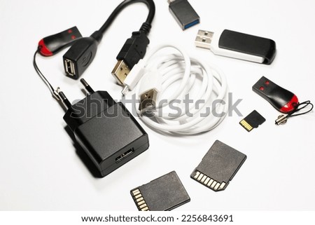 Charger cable and flash drive close-up on an isolated white background, usb, aux