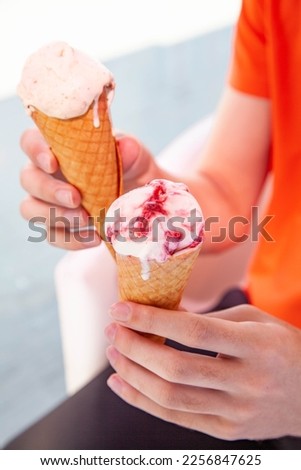 Hand holding gelato cone ice cream in two hands 