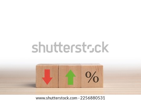 Icon for the percentage symbol on a cube. Concept of financial interest rates and mortgage rates. Change from down to up arrow on wood cube. Stocks, interest rate, and ranking. Concept of business.