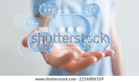 Businessman using digital blue speech bubbles talk icons. Minimal conversation or social media messages floating over user hand. 3D rendering